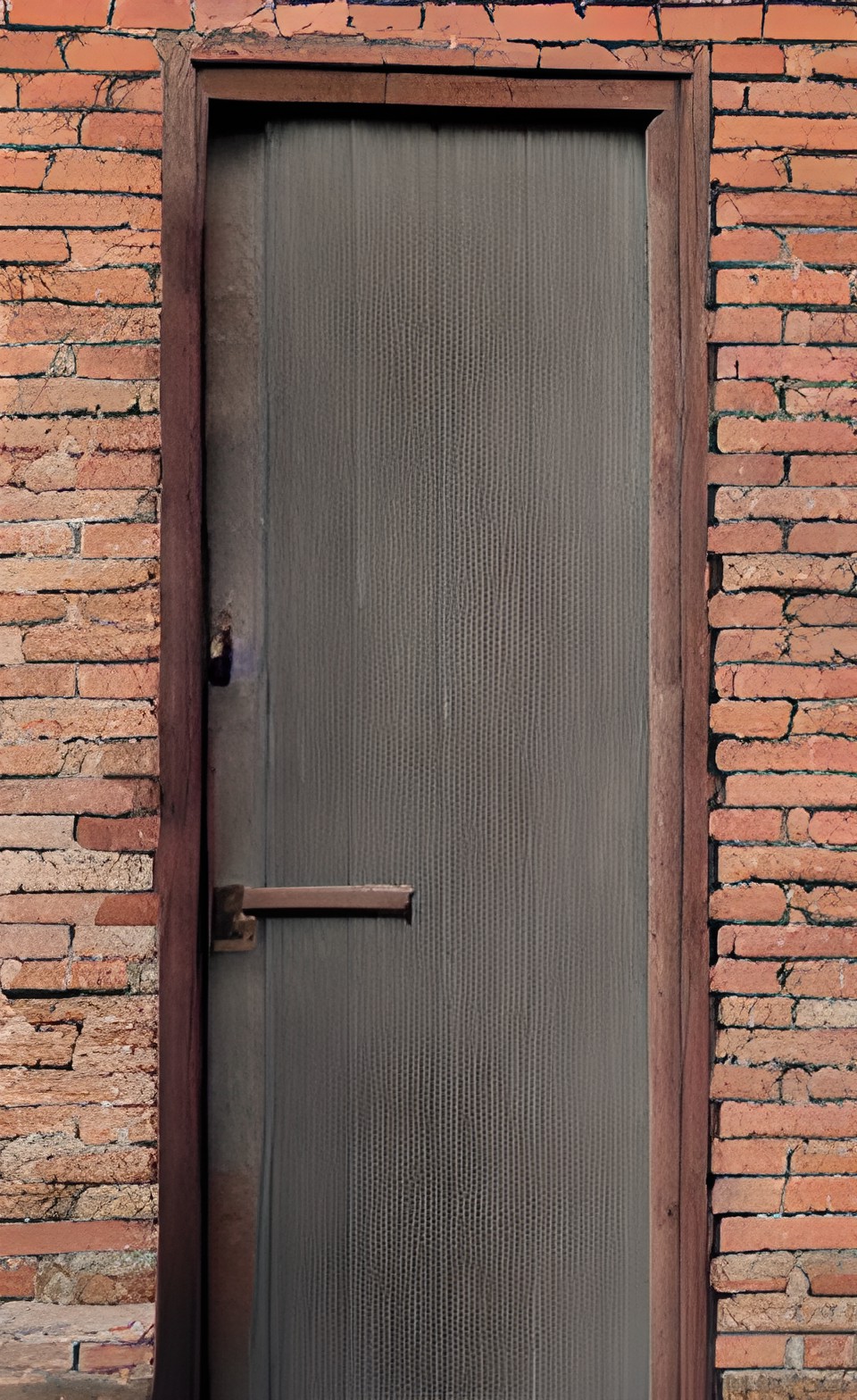 a large heavy wooden door in a brick wall preview