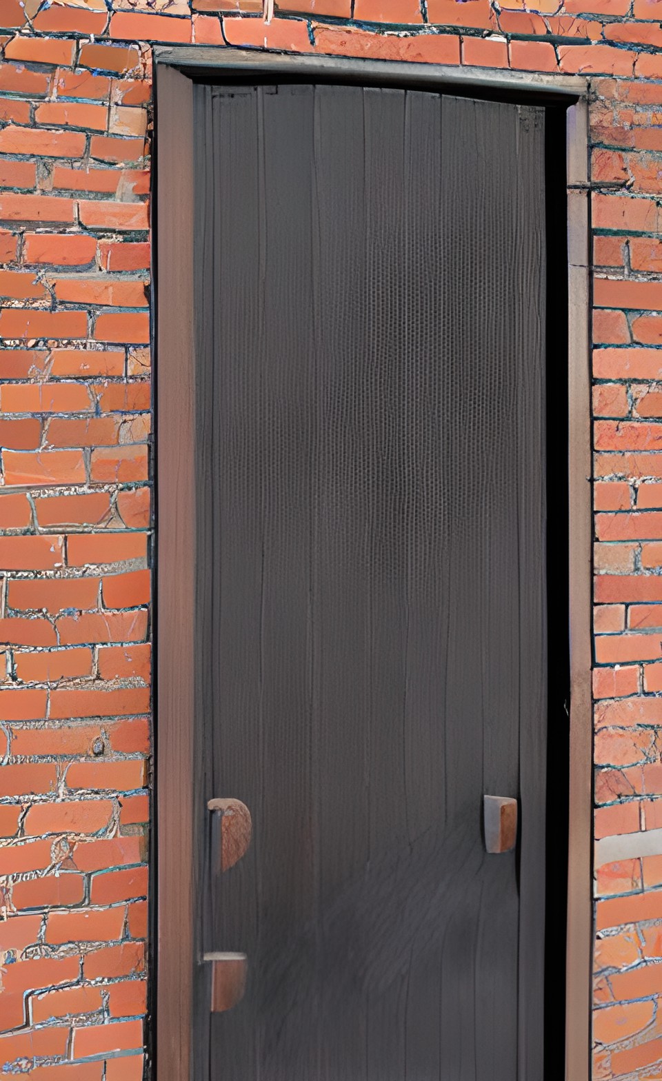 a large heavy wooden door in a brick wall preview