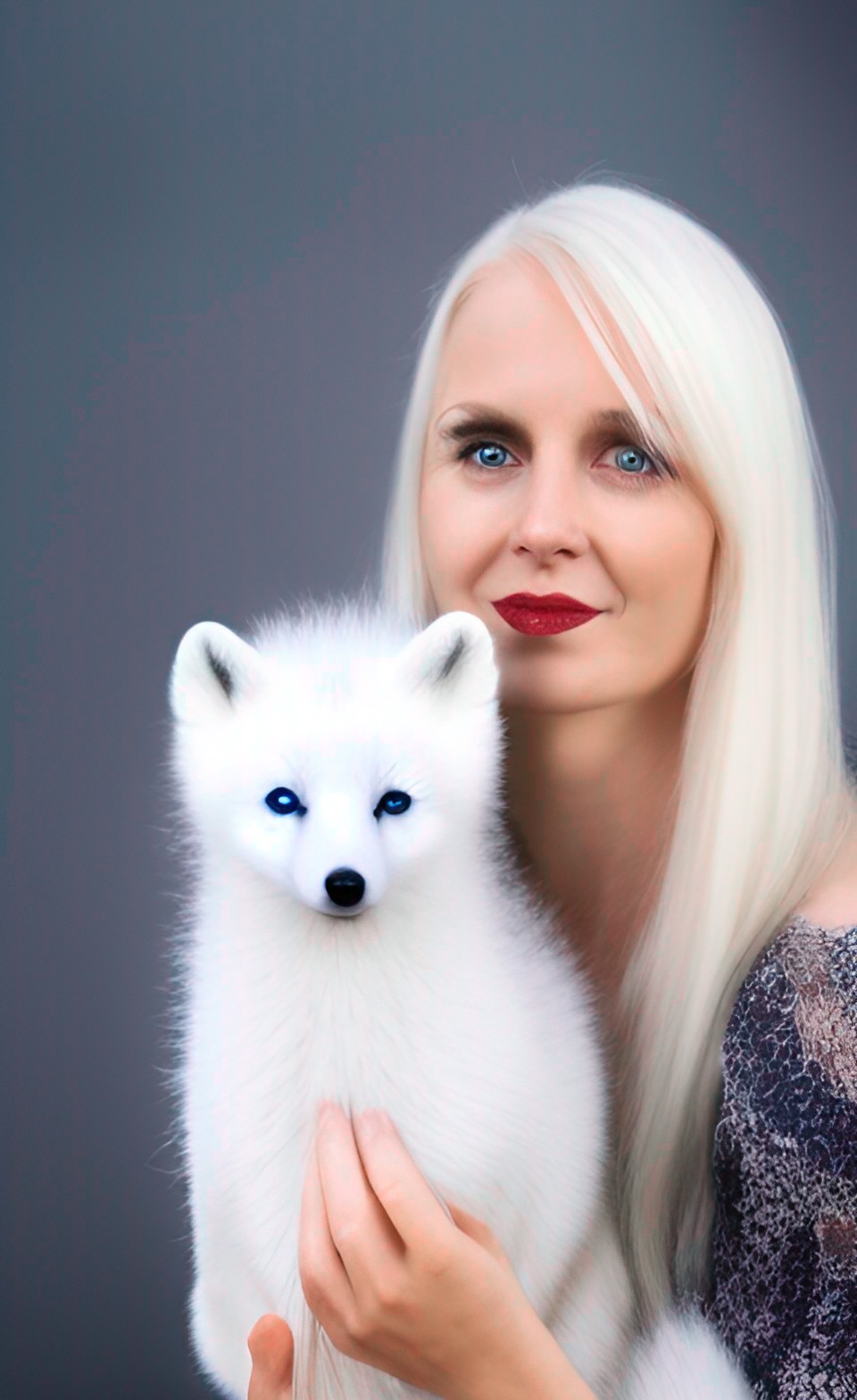 platinum blonde woman holding an arctic fox preview